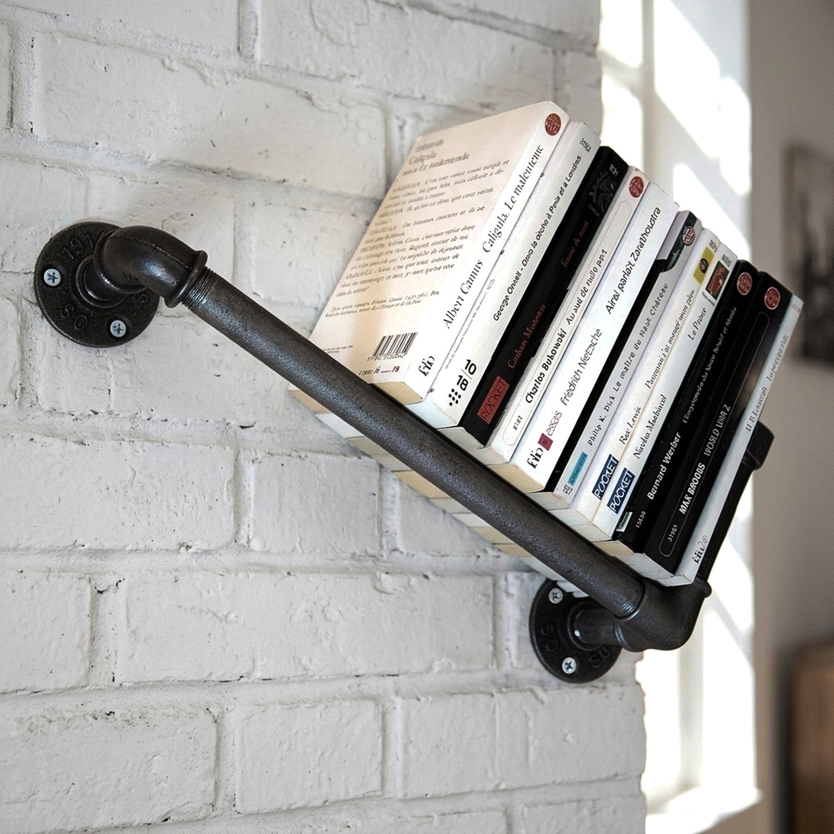 Wandregal aus Temperguss an Ziegelwand mit Büchern, Loft-Ambiente