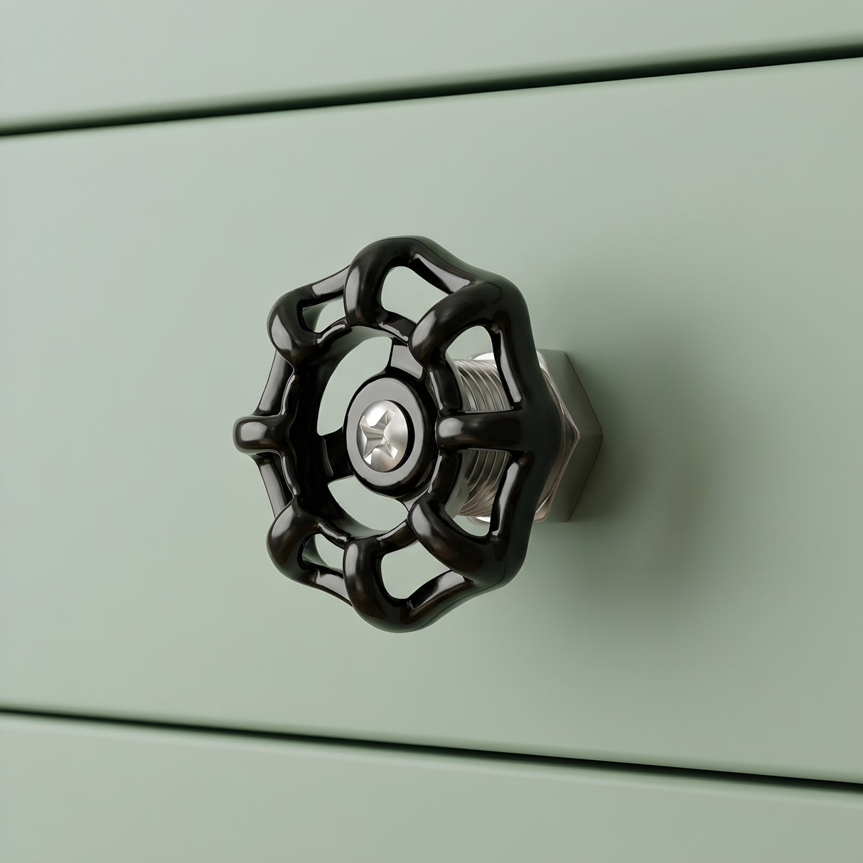 Bouton de meuble volant noir sur tiroir vert sauge