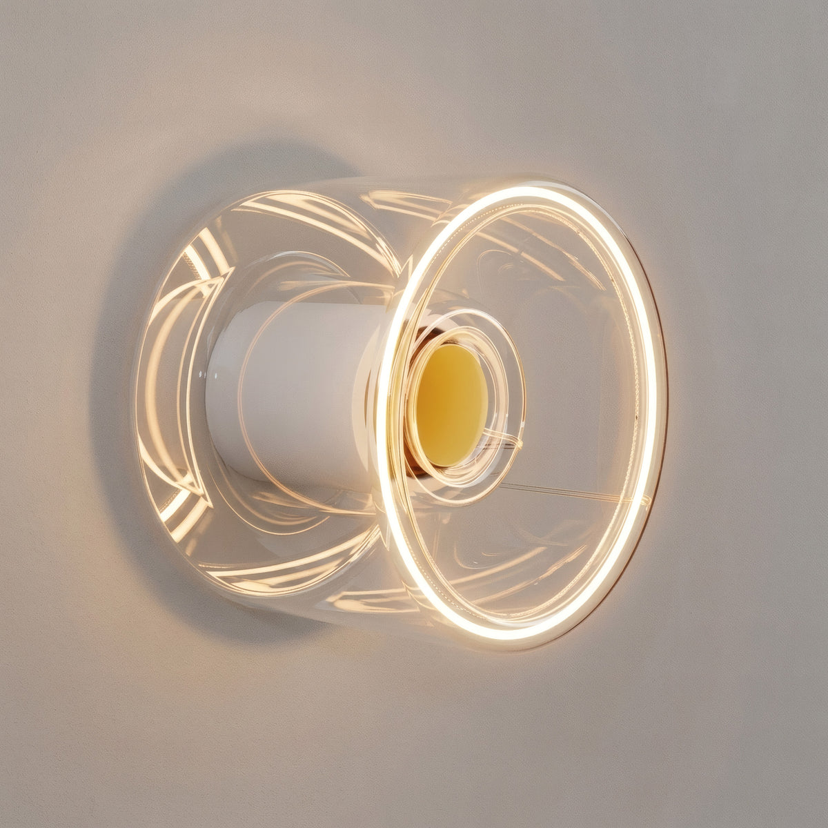 LED-Donut-Lampe E27 aus klarem Glas, Ø 120 mm, eingeschaltet als Wandleuchte in minimalistischer Einrichtung